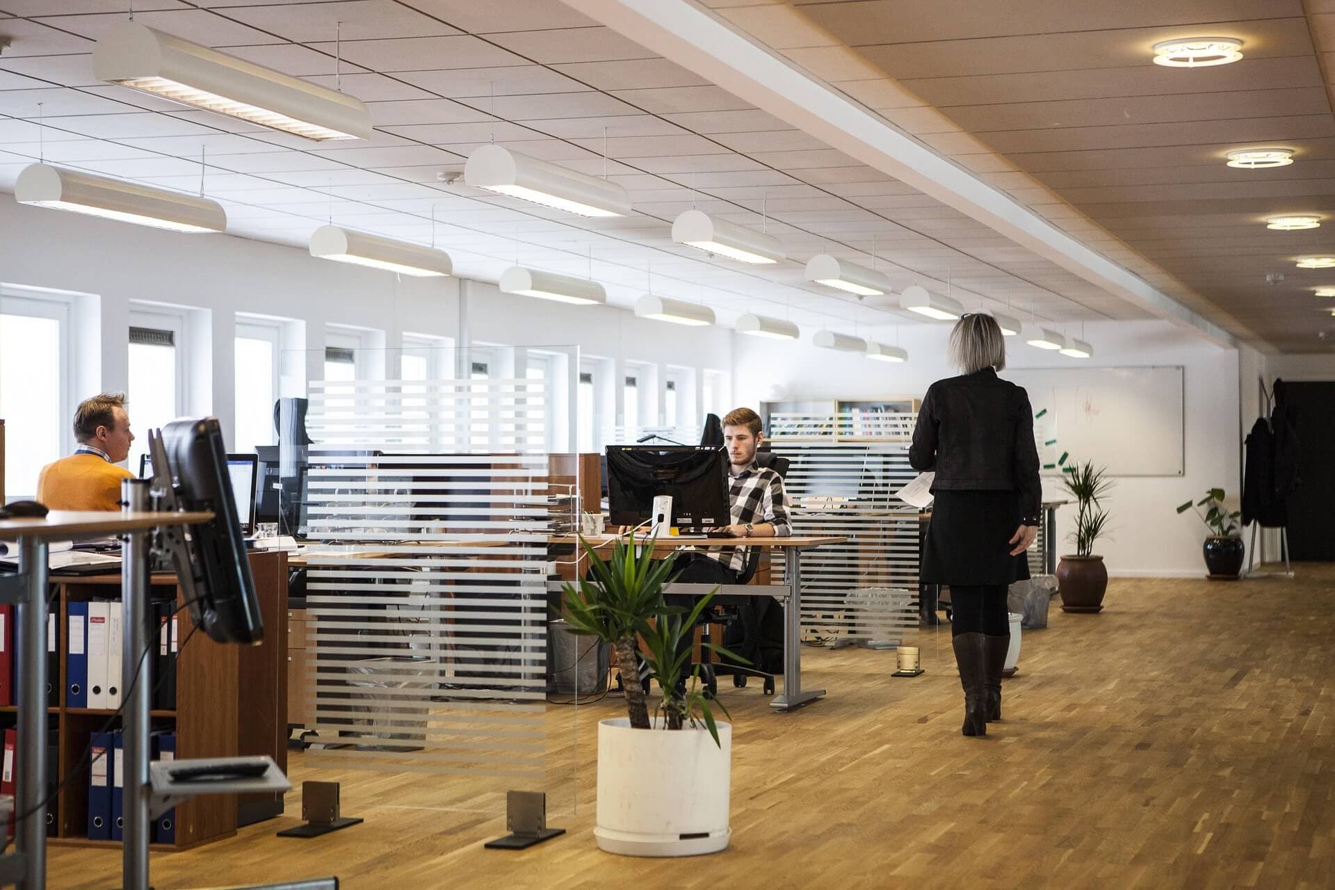 Team members at their desks in a modern office, the kind of workplace GPI Connect tracks presence for